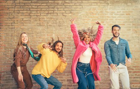 Happy friends having fun together outdoor - Crazy young people dancing and celebrating in the city - Concept of friendship with celebration and youth lifestyleの写真素材