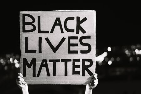 Black lives matter banner - Activist movement protesting against racism and fighting for equality - Social protests and human rights concept - Black and white editingの写真素材