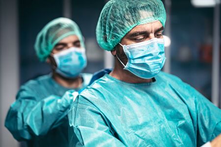 Doctors preparation for surgical operation in hospital during corona virus outbreak - Medical workers getting ready for fighting against coronavirus pandemic - Healthcare medicine conceptの写真素材