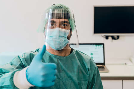Doctor wearing ppe face surgical mask and visor fighting against corona virus outbreak - Health care and medical workers conceptの写真素材