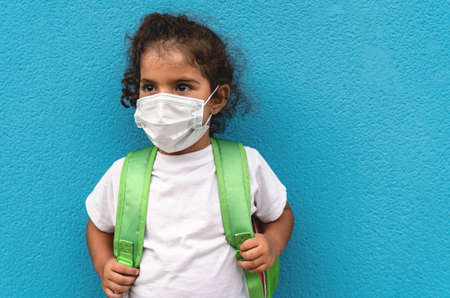 Child wearing face protective mask going back to school during corona virus pandemic - Healthcare...