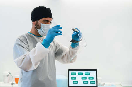 Doctor wearing ppe face surgical mask and visor fighting against corona virus outbreak - Health care...