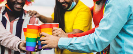 Happy multiracial people cheering and drinking cocktails in gay pride festival event during corona virus pandemicの写真素材