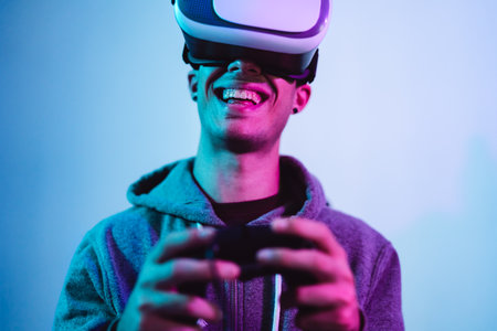 Young gamer playing to new video games with virtual reality experience - Youth people entertainment and technology conceptの写真素材