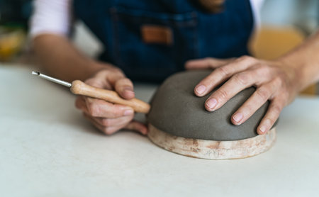 Close up female potter modeling clay bowl in workshop - Artisan work and creative craft conceptの写真素材