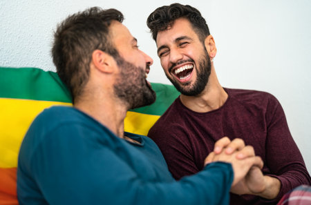Happy gay couple having tender moments in bedroom - Homosexual love relationship and gender equality...