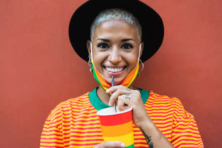 Young woman drinking cocktail during gay pride event - LGBT social movement conceptの写真素材