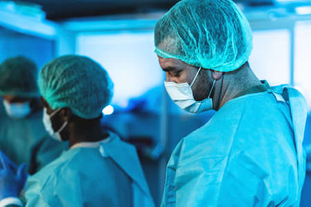 Doctors preparing inside surgical operation room - Medical workers getting ready for fighting against  pandemic - Healthcare medicine conceptの写真素材