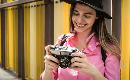 Young travel woman photographing with old vintage camera during vacation