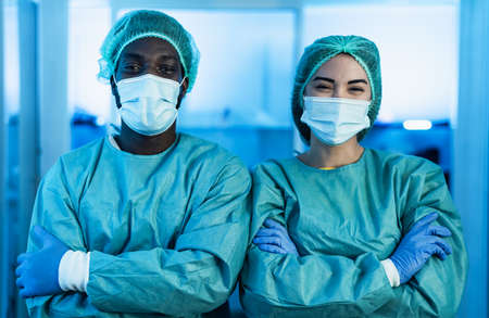 Multiracial doctors wearing personal protective equipment fighting against corona virus outbreak - Health care and medical workers conceptの写真素材