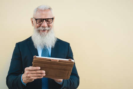 Senior business man working on digital tablet outdoor - Entrepreneurship and technology concept