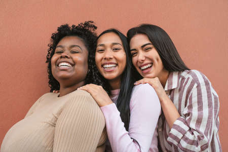 Happy multiracial friends having fun smiling together in front of cameraの写真素材