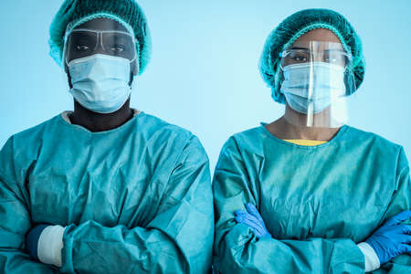 Multiracial doctors wearing personal protective equipment fighting against virus outbreak - Health care and medical workers conceptの写真素材