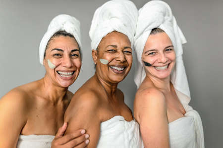 Happy multiracial senior women having skin care spa day - People wellness lifestyle conceptの写真素材