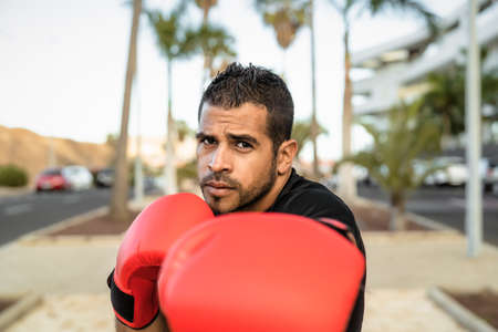 Young Latin man doing boxing exercises session outdoor - Health fitness and workout conceptの写真素材