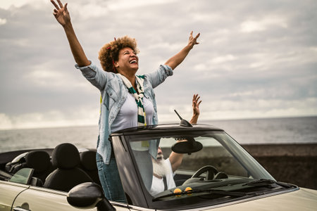 Happy senior couple having fun driving on new convertible car - Mature people enjoying time together...
