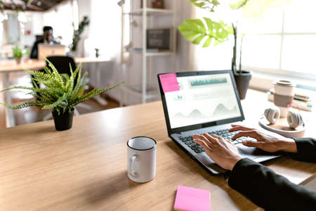 Close up of business trader woman working on crypto currency markets in creative co-working studio -...