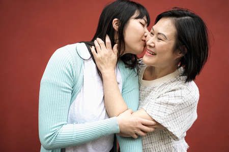 Happy Asian mother and daughter having tender moment together - Parents love conceptの写真素材