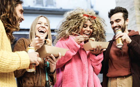Young multiracial friends having fun eating street food and drinking beer - Youth millennial lifestyle conceptの写真素材