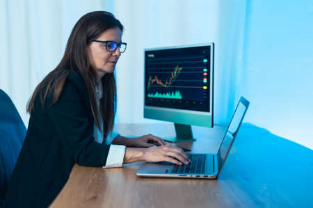 Business trader woman working on crypto currency markets with blockchain technology - Decentralized finance and stock exchange conceptの写真素材