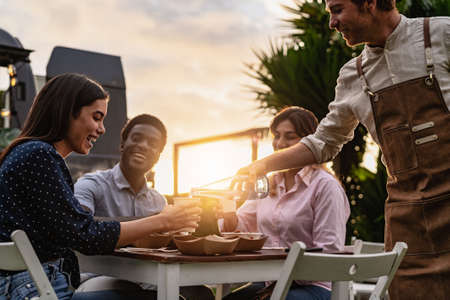 Happy multiracial people having fun eating in a street food truck market