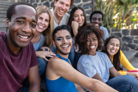 Young multiracial group of friends taking selfie sitting on urban stairs - Youth millennial...