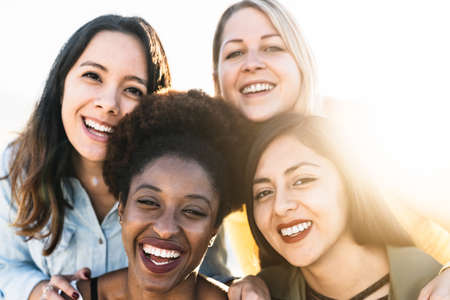 Portrait of happy multiracial women having fun outdoorの写真素材