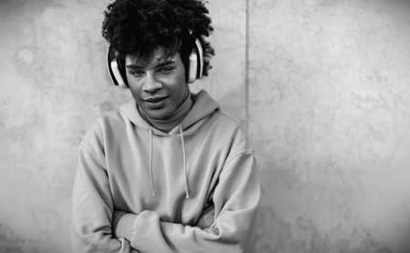 Happy Afro man listening music with wireless headphones outdoor - Youth millennial generation lifestyle conceptの写真素材