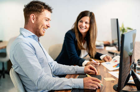 Happy digital content creators working in coworking creative space