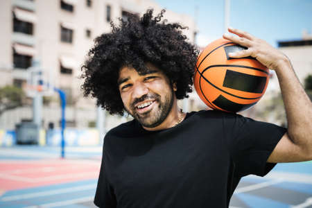Happy Afro man playing basketball outdoor - Urban sport lifestyle conceptの写真素材