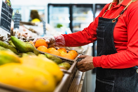 Woman working inside organic fresh supermarketの写真素材