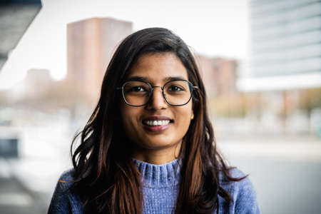Portrait of Indian girl smiling in the roomの写真素材