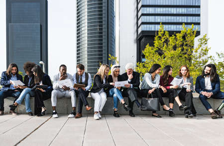 Panoramic view of business people having a briefing outside the officeの写真素材