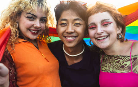 Happy gay friends having fun together during pride festival - LGBT and youth people lifestyle...