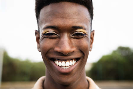 Happy African gay man smiling in front of cameraの写真素材