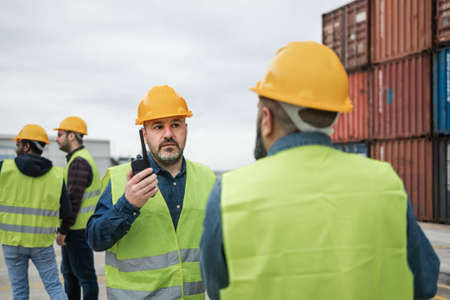 Industrial engineers working in logistic terminal of container cargoの写真素材