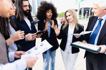 Multiracial business people having a briefing outside the office