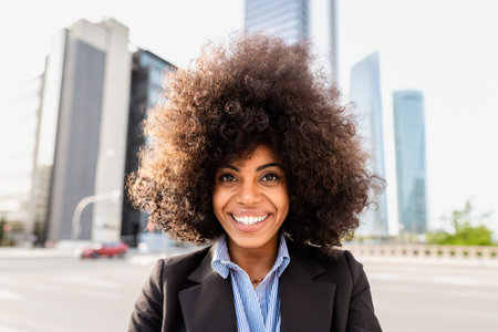 Business woman having fun looking in front of camera - Urban view and skyscrapers in the background
