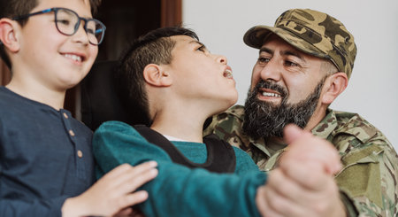 Military soldier having tender moment together his son with disability at home - Family love conceptの写真素材