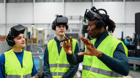 Team of multiracial engineers having a simulation experience with futuristic virtual reality glasses inside robotic factory - Tech industry and metaverse conceptの写真素材
