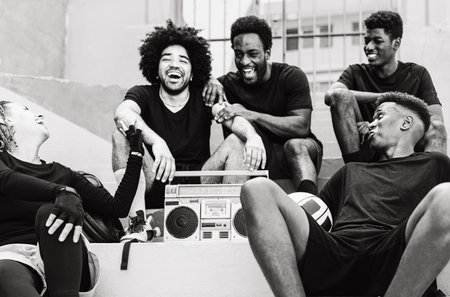 Group of multiracial people having fun listening music with vintage boombox stereo - Urban street people lifestyle - Black and white editingの写真素材