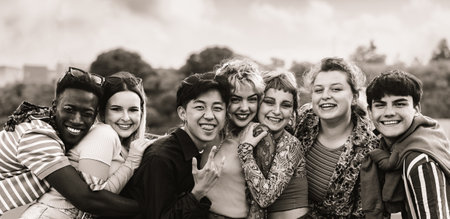 Young multi ethnic friends having fun together hanging out in the city - Friendship and diversity concept - Black and white editingの写真素材