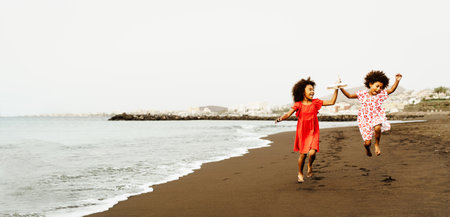 Happy African children having fun on the beach during summer holidaysの写真素材