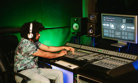Young audio engineer mixing a sounds in music recording studio - Youth musician people lifestyle conceptの写真素材