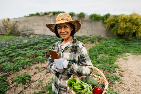 Happy southeast Asian woman working inside agricultural land - Farm people lifestyle conceptの写真素材