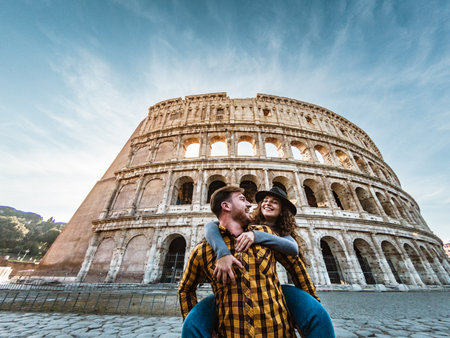 Happy young romantic couple having fun together in Rome Colosseum - Love relationship and travel lifestyle conceptの写真素材