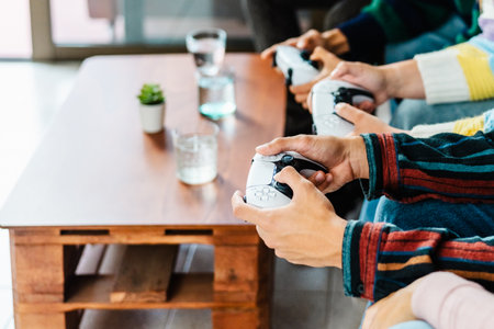 Young gamers playing online video game console at home - Youth people engaged in new technology...