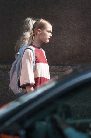 MILAN, ITALY - SEPTEMBER 23, 2017: Fashionable woman walking in the street after the ERMANNO SCERVINO fashion show at Milan Woman Fashion Week street style Spring / Summer 2018のeditorial素材
