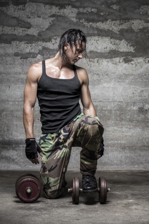 handsome muscular man looking downの写真素材