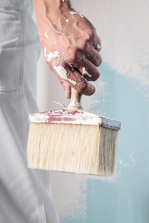 Close up Of Professional Workman Hand holding Dirty Paintbrushの写真素材